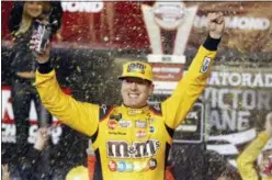  ?? STEVE HELBER — THE ASSOCIATED PRESS ?? Kyle Busch celebrates in Victory Lane after winning the NASCAR Cup Series race at Richmond Raceway last weekend Saturday.