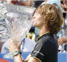  ??  ?? WASHINGTON: Alexander Zverev, of Germany, kisses the trophy after he defeated Kevin Anderson, of South Africa, to win the Citi Open tennis tournament, Sunday, in Washington. — AP