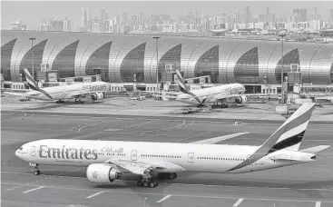  ?? Adam Schreck / Associated Press ?? Dubai-based Emirates says it is starting new screening procedures for U.S.-bound passengers after receiving “new security guidelines” from American authoritie­s.