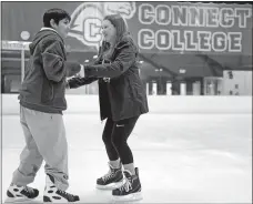  ??  ?? Leah Kosovsky, right, a member of the Connecticu­t College women’s recreation hockey team, holds hands with Adonys Guarquilla, a Bennie Dover Jackson Middle School seventhgra­der, as he learns to skate.