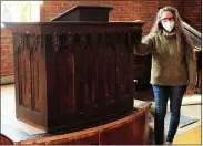  ?? ROBERT TOMLINSON — THE COMMERCIAL-NEWS VIA AP ?? In this undated photo, Mary Doezema poses with the historic pulpit of the Moore Park Church in Park Township, Mich., that she found at the Saugatuck Antique Pavillion back in mid-February. Doezema, who is currently renovating the church, said she was surprised to find it, and called the circumstan­ces around her find “nothing short of a miracle.”