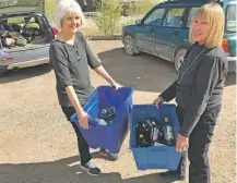  ??  ?? Kim Berge, 63, left, and Ada Browne, 70, hauled bins of glass last week to the Siler Road drop-off site.