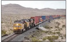  ?? STEVE MARCUS ?? A freight train heads south Wednesday near Sloan, south of Las Vegas. Nevada lawmakers are considerin­g legislatio­n that would require devices be placed along railways throughout the state to detect potentiall­y defective equipment and alert the onboard crew.