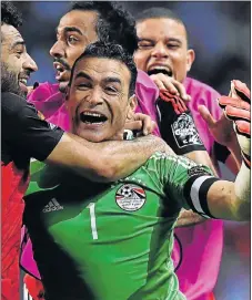  ?? Picture: AFP ?? OUR HERO: Egypt goalkeeper Essam El Hadary celebrates with his teammates at the end of the penalty shootout in the Africa Cup of Nations semifinal against Burkina Faso