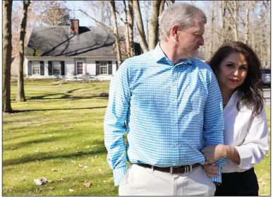  ?? (AP/Tony Dejak) ?? Matt Moorhead of Warren, Ohio, said he spent about six months “trying to be a dad through a cellphone” as he worked at a General Motors plant in Lansing, Mich., until his wife, Alyson (right), persuaded him to quit his job.