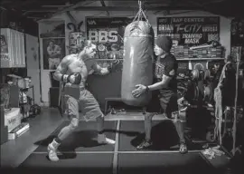  ?? Jay L. Clendenin Los Angeles Times ?? BRIAN ORTEGA TRAINS in the garage of his trainer, James Luhrsen, right, in February. The UFC fighter spends much of his time on social causes.