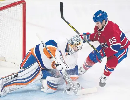  ??  ?? Islanders goalie Thomas Greiss, left, makes a save against the Canadiens’ Andrew Shaw during the first period.