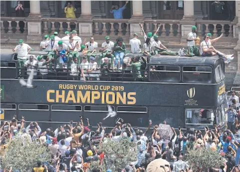  ?? AP ?? Fans cheer as the bus of the Springboks team passes during a victory parade in Pretoria yesterday.