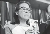  ?? JUSTIN TANG THE CANADIAN PRESS ?? Debbie Baptiste, mother of Colten Boushie, holds a photo of her son, who was fatally shot by a farmer in 2016.