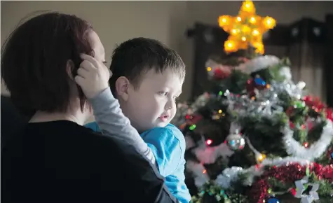  ?? PETER POWER/for National Post ?? Evan Leversage, 7, who is battling cancer, at his home with his mother, Nicole Wellwood in St. George, Ont. The town is celebratin­g Christmas early this
year, and Evan is curious what all the fuss is about. She told him, ‘Because you have a whole town...