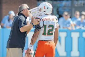  ?? GRANT HALVERSON / GETTY IMAGES ?? Miami coach Mark Richt and quarterbac­k Malik Rosier are offff to a 7-0 start this season, but they could be due for a reality check against Virginia Tech this week. The Hurricanes haven’t played a team currently in the CFP top 25.