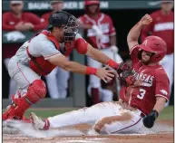  ?? (NWA Democrat-Gazette/Andy Shupe) ?? Arkansas’ Zack Gregory (right) is tagged out at the plate by Georgia catcher Corey Collins during the first inning of Saturday’s game at Baum-Walker Stadium in Fayettevil­le. More photos available at arkansason­line.com/59ugaua.