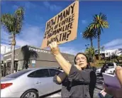  ?? Brian van der Brug Los Angeles Times ?? VOLUNTEER organizer Elizabeth Fernandez pickets outside a Starbucks in Los Angeles on Nov. 16.