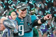  ?? FRANK FRANKLIN II/AP PHOTO ?? Eagles’ Nick Foles holds his daughter, Lily, after beating the Patriots on Sunday night in Super Bowl 52 in Minneapoli­s.