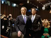  ?? TOM BRENNER / NEW YORK TIMES ?? Mark Zuckerberg (left), founder and CEO of Facebook, arrives Tuesday in a hearing room on Capitol Hill in Washington, D.C., to testify before the Senate Judiciary and Commerce committees. Zuckerberg will also speak today to the House Energy and...