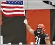  ?? RON SCHWANE — THE ASSOCIATED PRESS ?? Andy Janovich holds up a United States flag before a game against the Texans.
