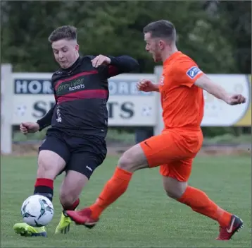  ??  ?? Ryan Nolan of Wexford F.C. tries to skip past the challenge of Kealan Dillon of Athlone Town.