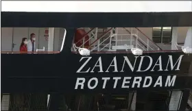  ??  ?? Two people look off the stern of the cruise ship Zaandam after it docked Thursday at Port Everglades in Fort Lauderdale, Fla.
(AP/Wilfredo Lee)