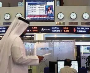  ??  ?? Dubai listing: Traders working at the Dubai Financial Market. Emaar Properties shares are scheduled to be listed on Nov 22. — Reuters