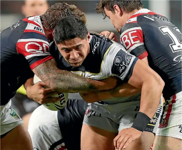  ??  ?? Kiwis and Cowboys enforcer Jason Taumalolo charges through the Roosters defence last night.