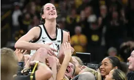  ?? Photograph: Jeffrey Becker/USA Today Sports ?? Iowa Hawkeyes guard Caitlin Clark is hoisted aloft by her teammates after breaking the NCAA women’s all-time scoring record on Thursday against the Michigan Wolverines at Carver-Hawkeye Arena.