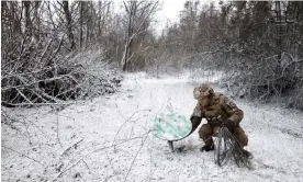  ?? Photograph: Clodagh Kilcoyne/Reuters ?? A Ukrainian soldier disconnect­s a Starlink terminal on the frontline in the Luhansk region.