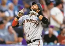  ?? David Zalubowski / Associated Press ?? Brandon Crawford hit two homers in the opener and kept it up with this solo shot off Chi Chi Gonzalez in the nightcap.