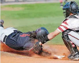  ?? [PHOTO BY BRYAN TERRY, THE OKLAHOMAN] ?? Westmoore’s Zac Johnson is tagged out at home by Mustang’s Noah Barks during Mustang’s 7-3 win Friday at Edmond Memorial during the Central Oklahoma Athletic Conference Tournament.