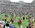  ?? Picture: GALLO IMAGES/PHILIP MAETA ?? PITCH INVASION: Orlando Pirates fans storm the pitch after their team's 3-0 MTN8 semifinal second leg victory against Mamelodi Sundowns at Peter Mokaba Stadium in Polokwane last month.