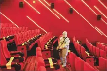  ?? Reuters ?? A worker sanitises seats inside a movie theatre ahead of its reopening, amid the outbreak of the pandemic in Mumbai.