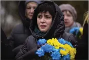  ?? EMILIO MORENATTI — THE ASSOCIATED PRESS ?? A woman cries during a memorial service in a cemetery in Bucha, Ukraine, on Friday to mark the one-year anniversar­y of the start of the Russia Ukraine war.