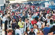  ?? Virendra Saklani/Gulf News ?? Racing enthusiast throng the Yas Marina Circuit during the pit lane walk yesterday.