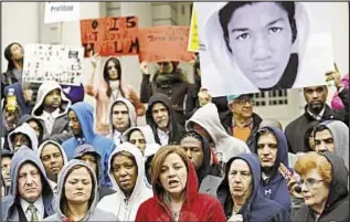  ??  ?? Speaker Christine Quinn (c.) joins City Council members and others in hoodies during press conference on steps of City Hall to protest the shooting.