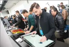  ?? DON EMMERT/AFP ?? Journalist­s and Microsoft fans get a look at the new Microsoft Surface Studio introduced at a Microsoft news conference on Tuesday in New York City.