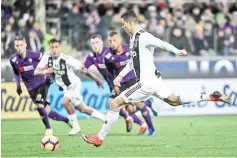  ??  ?? Juventus’s striker Cristiano Ronaldo from Portugal kicks a penalty to score during their Serie A football match Fiorentina versus Juventus on December 1, 2018 at the Artemio Franchi Stadium in Florence. - AFP photo