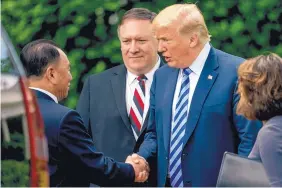  ?? ANDREW HARNIK/ASSOCIATED PRESS ?? President Donald Trump talks with Kim Yong Chol, former North Korean military intelligen­ce chief, as Secretary of State Mike Pompeo watches Friday.