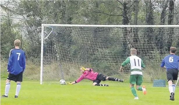 ??  ?? Bro Goronwy keeper Gareth Owen makes a vital penalty save against Talysarn to help his team to victory