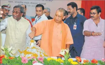  ?? HT PHOTO ?? Chief minister Yogi Adityanath cutting a 67 kg laddoo cake on Prime Minister Narendra Modi’s birthday in Varanasi on Sunday.