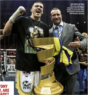  ??  ?? THE SPOILS OF WAR: The new undisputed champion with the WBSS trophy, as promoter Kalle Sauerland commiserat­es with Gassiev [below]