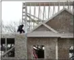  ?? ELISE AMENDOLA — THE ASSOCIATED PRESS ?? Constructi­on workers build new housing in Salisbury, Mass.