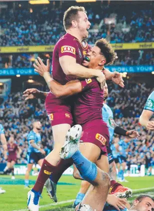  ??  ?? DONE IT: Michael Morgan and Dane Gagai celebrate the Maroons’ match- winning try.