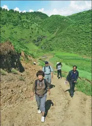  ??  ?? Zhang on her way to a remote village by foot in 2006.