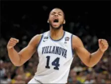  ?? ERIC GAY — THE ASSOCIATED PRESS ?? Villanova forward Omari Spellman celebrates during the first half against Kansas in the semifinals of the Final Four on Saturday. The Wildcats face Michigan in the title game on Monday.