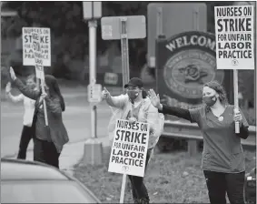  ?? PHOTOS BY SEAN D. ELLIOT/THE DAY ?? Above, members of the Backus Federation of Nurses, AFT Connecticu­t, Local 5149, from right, Marylin Morton, Amy Sinko, Julie Alfredson and Rachel Bissonette picket Tuesday, the first day of a two-day strike, at the hospital in Norwich. Below, nurses hold signs and cheer as cars drive past. The 415-member union, which has been working without a contract since July 31, voted Sept. 13 to authorize the strike.