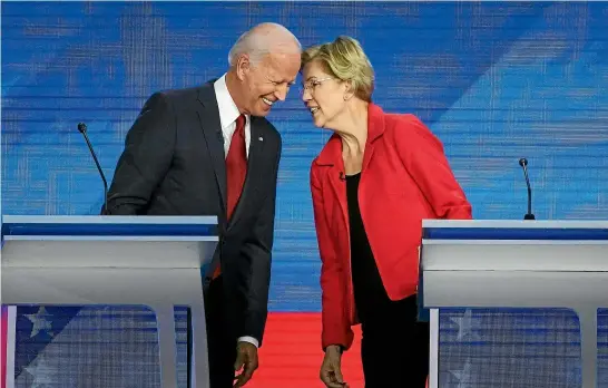  ?? AP ?? Democratic presidenti­al candidates former Vice President Joe Biden and Senator Elizabeth Warren, D-Mass, chat at the Democrats debate at Texas Southern University in Houston.