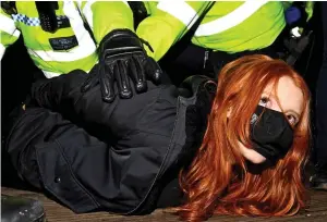  ?? ?? Arrest: Patsy Stevenson, 28, being held down by officers at the vigil