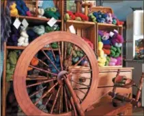  ?? PAUL POST — PPOST@DIGITALFIR­STMEDIA.COM ?? A spinning wheel, surrounded by colorful yarn, is the focal point of Carole Foster’s farm-based shop in Northumber­land.