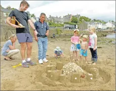  ?? 25_c32sandcas­tles03 ?? These castle builders shelled out.