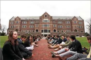  ?? SUBMITTED PHOTOS ?? Hill School students sat in the main academic quad of the campus before classes on March 25 to protest the firing of teacher Tracy McGrath.