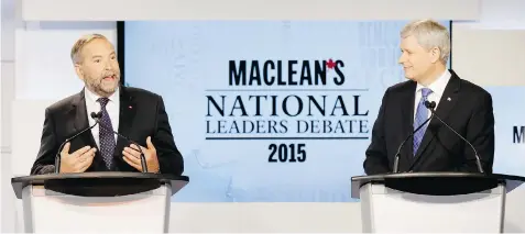  ?? MARK BLINCH/The Canadian Press ?? NDP Leader Tom Mulcair, left, speaks while Conservati­ve Leader Stephen Harper looks on Thursday during the national leaders debate in Toronto.